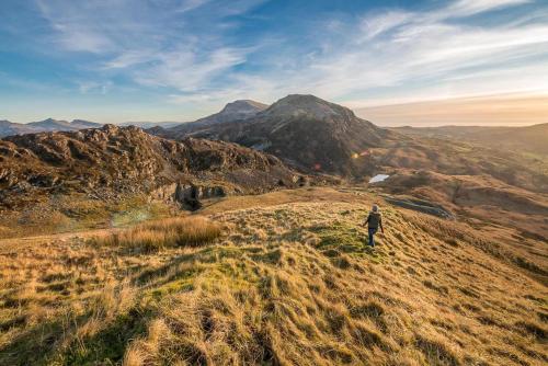 a person standing on top of a mountain at Hafod-Llecheiddior in Brynkir
