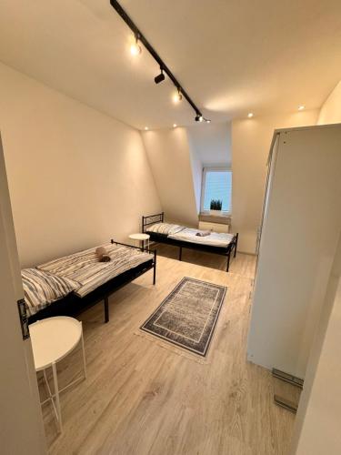 a room with two beds and a table at A&V Apartments Arena Nähe in Gelsenkirchen