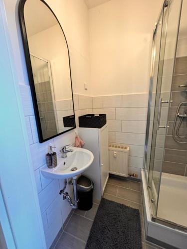 a bathroom with a sink and a shower at A&V Apartments Arena Nähe in Gelsenkirchen