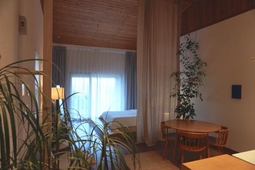 a room with a bedroom with a table and a bed at At corner resort & garden in Jeju
