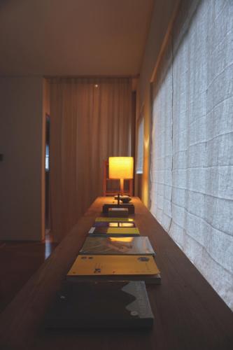a room with a table with a lamp on it at At corner resort & garden in Jeju