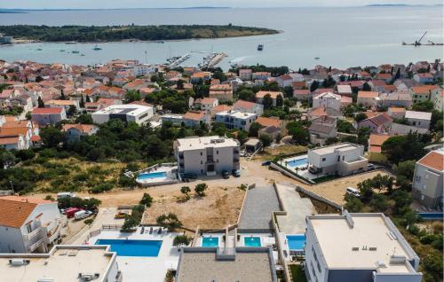 an aerial view of a city with houses and the water at Beautiful Home In Novalja in Donji Lapac