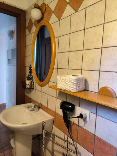 a bathroom with a sink and a mirror on the wall at La Corte in Morlupo