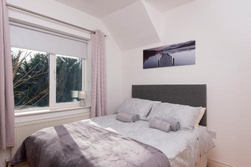 a bedroom with a large bed and a window at 5 Bruach na hAbhann in Clonakilty