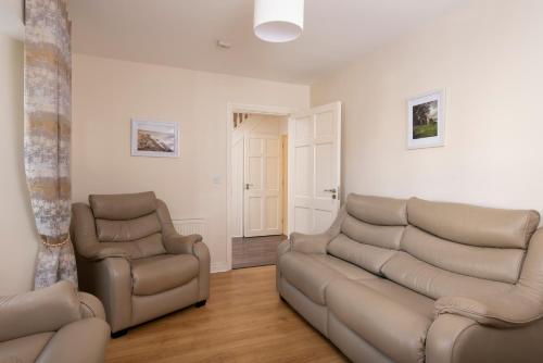 a living room with a couch and two chairs at 5 Bruach na hAbhann in Clonakilty