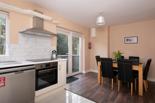 a kitchen and dining room with a table and chairs at 5 Bruach na hAbhann in Clonakilty