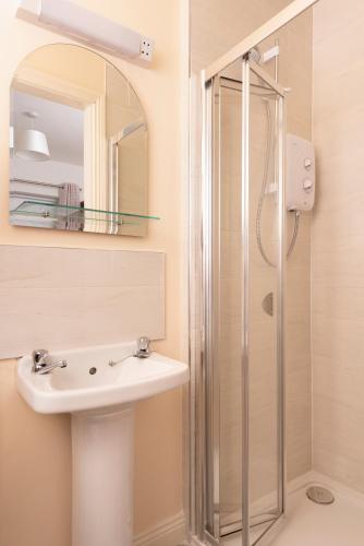 a bathroom with a sink and a shower at 5 Bruach na hAbhann in Clonakilty