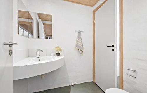 a bathroom with a sink and a mirror at Awesome Home In Nørre Nebel With Sauna in Nørre Nebel