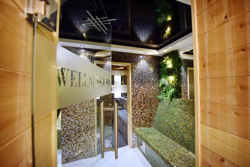a hallway with a green bench in a building at Dream House Hotel & Spa in Kolašin