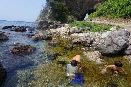 two boys playing in the water on the beach at Morizuya in Toyooka