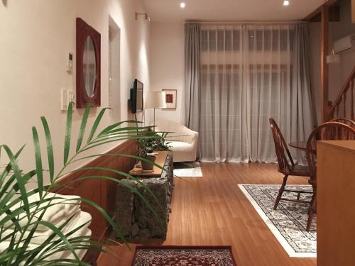 a living room with a couch and a plant at At corner resort & garden in Jeju