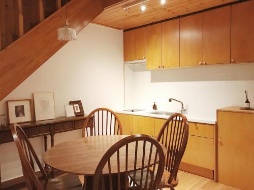 a kitchen with a table and chairs and a sink at At corner resort & garden in Jeju