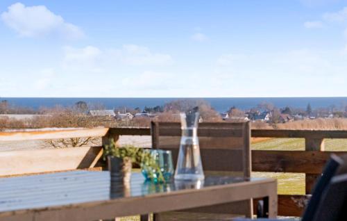a table with two glasses and a bottle on it at Amazing Home In Samsø With Wi-Fi in Brundby