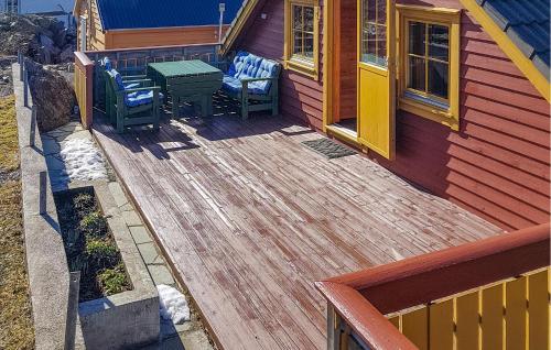 a deck with two chairs and a table on a house at Holiday Home Finnås Lyklingsjøvegen in Lykling