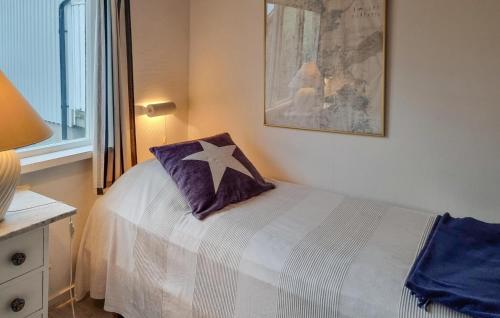 a bedroom with a bed with a pillow on it at Lovely Home In Hönö With Harbor View in Hönö