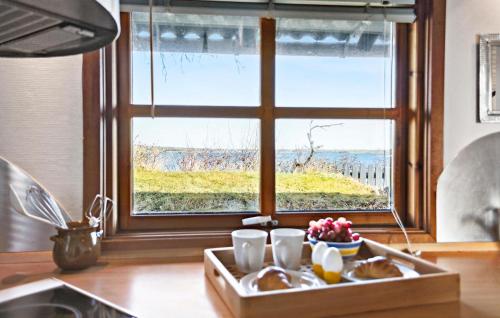 a tray of food on a kitchen counter with a window at 1 Bedroom Cozy Home In Munkebo in Munkebo