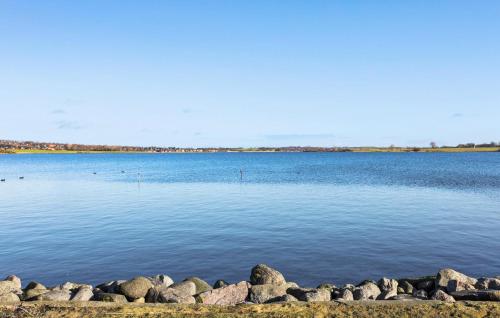 a large body of water with rocks in the foreground at 1 Bedroom Cozy Home In Munkebo in Munkebo