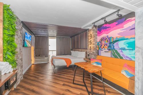 a bedroom with a bed and a colorful mural at Ocean Front Queen Suite With Panoramic Views! - Compass Cove Unit 964 in Myrtle Beach