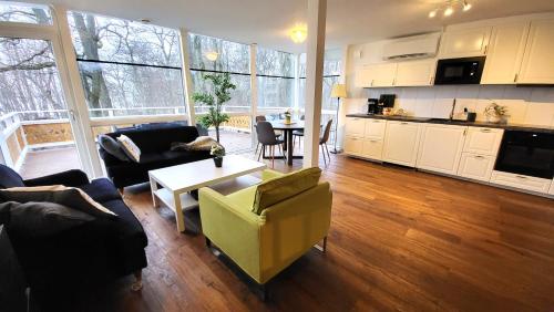 a living room with a couch and a table at Beautiful lakefront house in Västerås