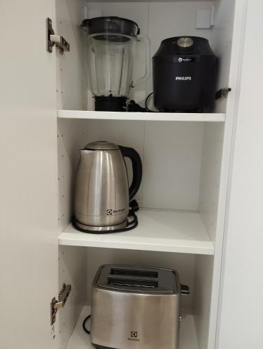 a kitchen pantry with a blender and a toaster at Au coucher du lac in Publier