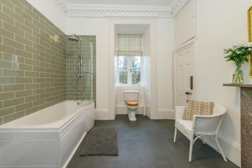 a bathroom with a tub and a toilet at Gors-Y-Gedol in Dyffryn