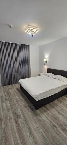 a bedroom with a large bed and a wooden floor at Lotus 