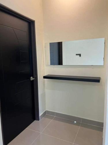 a bathroom with a black door and a mirror at D Sayang Homestay Parit Buntar MUSLIM SAHAJA in Parit Buntar