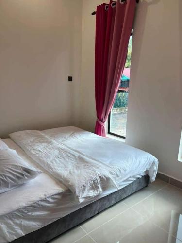a bed in a room with a window at D Sayang Homestay Parit Buntar MUSLIM SAHAJA in Parit Buntar