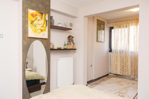a bedroom with a mirror and a bed at Cozy home in Ioannina