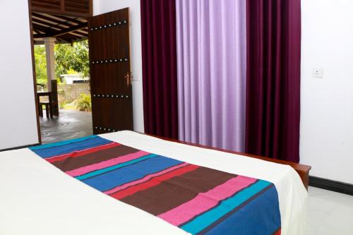 Postel nebo postele na pokoji v ubytování Silent Beach Homestay
