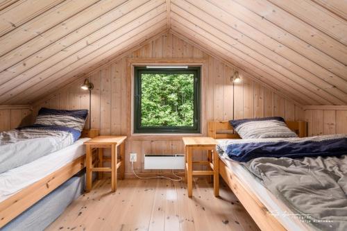 a cabin with two beds and a window at Ål Skisenter - Cabin with panoramic view for 8 guests in Holo