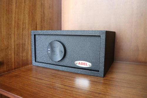 a small television with a remote control on a table at Hotel San Agustin Plaza in Latacunga