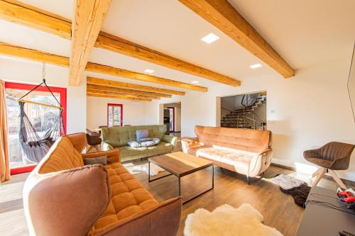 a living room with a couch and a table at Chalupa KARKULKA in Hostice