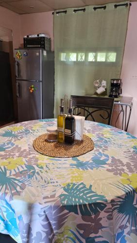 a kitchen with a table with a flower patterned table cloth at Cozy Home in Volcán