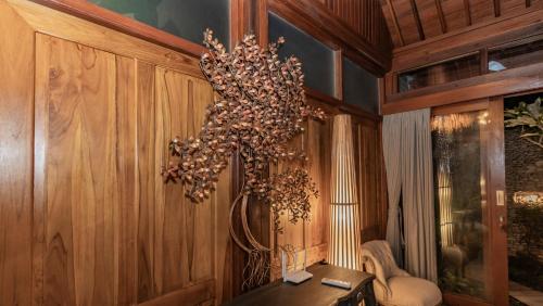 a chandelier hanging from a wall in a room at Ganesh Villa in Ubud