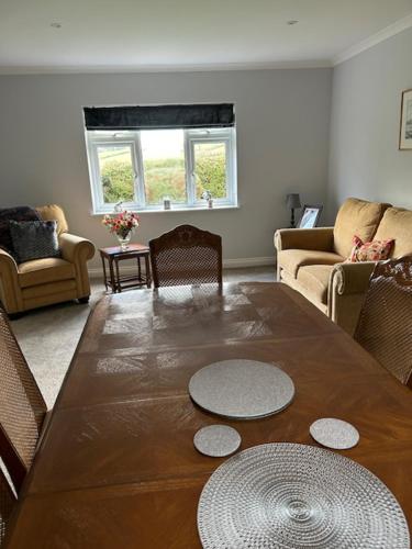 a living room with a wooden table and chairs at Rock Park Farm B&B in Crediton