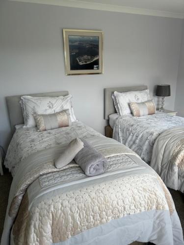 a bedroom with two beds and a picture on the wall at Rock Park Farm B&B in Crediton
