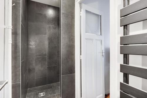 a shower with a glass door in a bathroom at UNESCO-SUFFREN in Paris