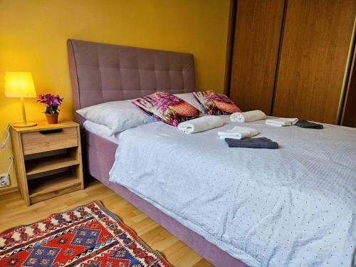 a bedroom with a bed with towels on it at Sunny & Spacious, 10mins to Centre, Free parking, Quiet location, New Furniture, Balcony in Prague