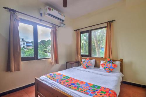 a bedroom with a bed and a large window at Hilltop 3BHK Villa With Private Pool Near Candolim in Candolim