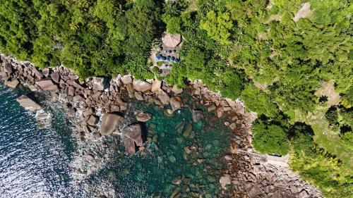 an aerial view of a rocky shore with water at CASA DE TUCA in Ilhabela