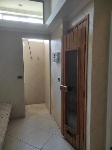 a bathroom with a shower and a wooden door at Viña del mar in Viña del Mar