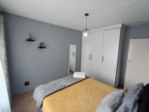 a bedroom with a large bed in a room at Maneli 69 in Boksburg