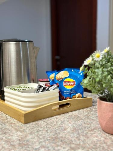 a cutting board with some food and a bag of chips at Lux-Room in Deira DXB near Union Metro by Z-Residence in Dubai