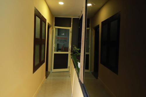 a hallway leading to a door with a sign on it at Comfort INN in Payyannūr