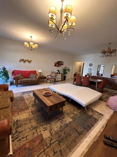 een grote woonkamer met een bed en een tafel bij Mivida for rent in New cairo