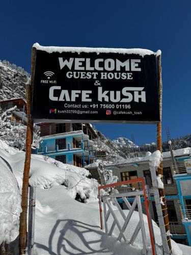 a sign for a guest house in the snow at Cafekush tosh in Tosh