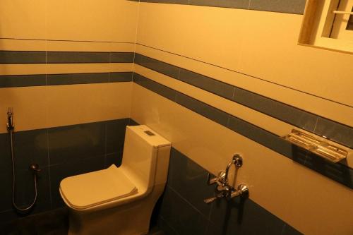 a bathroom with a toilet and a sink at AzureVista homestay in Anaviratty