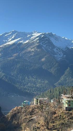 a view of a snow covered mountain with a city at Cafekush tosh in Tosh