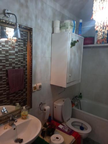 a bathroom with a sink and a toilet and a mirror at Mística INTERNET in Arona